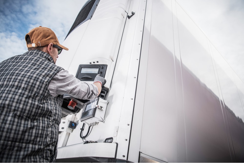 A CDL truck driver setting the temperature for a reefer truck